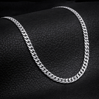 Encliff Cuban link chain with thick, interlocking gold-toned links, showcasing a stylish and durable jewelry piece.