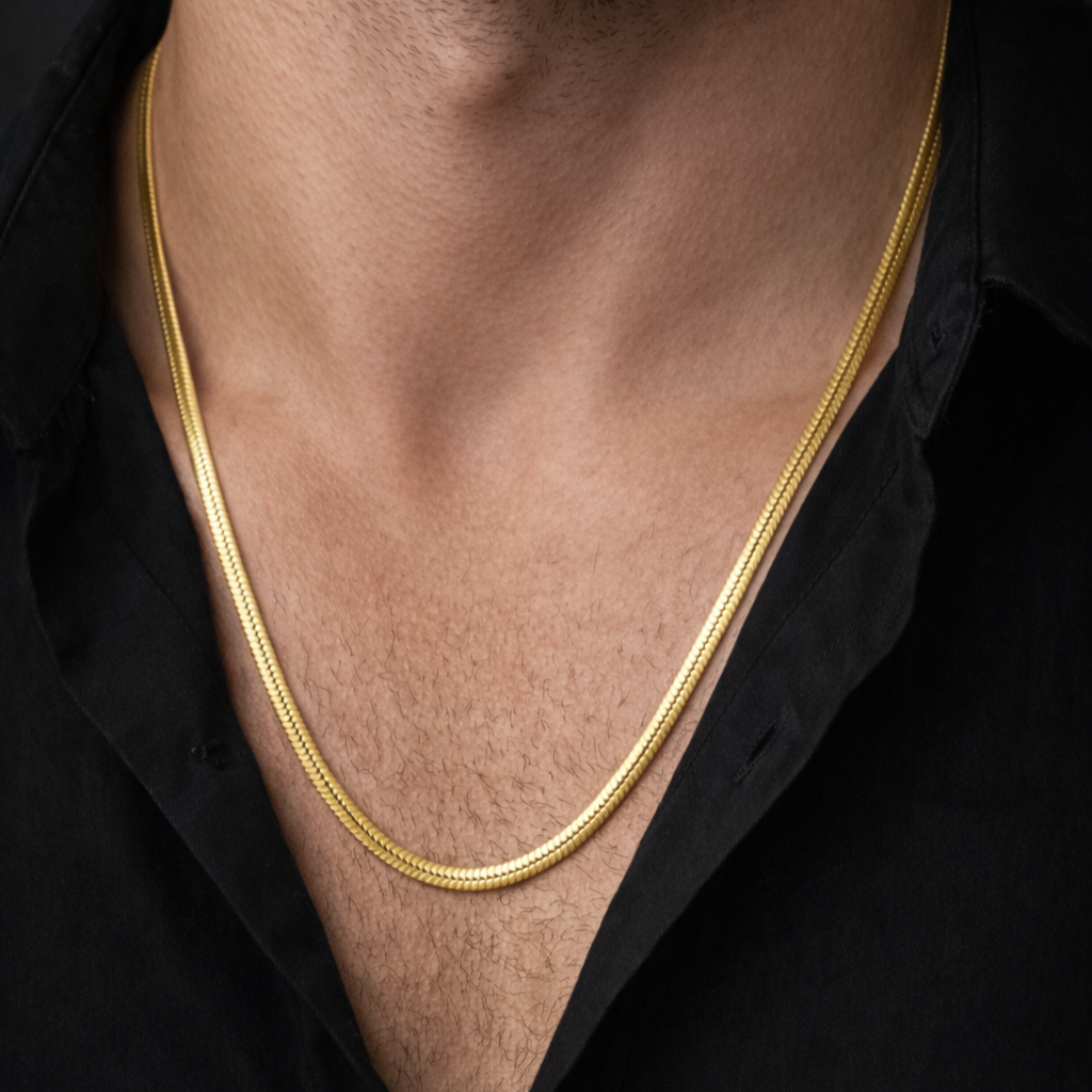Shiny silver Encliff snake chain necklace with smooth, flexible links lying flat against a white background.